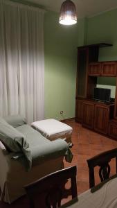 a room with two beds and a flat screen tv at Tenuta Rio del Sole-Appartamento in Albairate