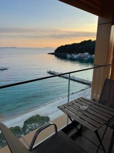 a balcony with a table and a view of the water at Hotel Veizi in Himare