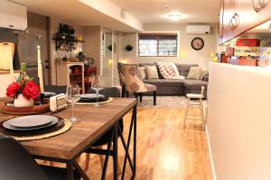 a kitchen and living room with a table and a couch at Nestled Inn Bed and Breakfast in Victoria
