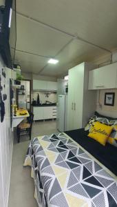 a bedroom with a large bed in a room with a kitchen at Blessed Homes in Braço do Norte