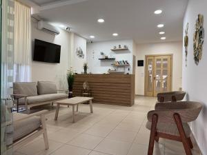 a living room with a couch and a tv at Hotel Veizi in Himare