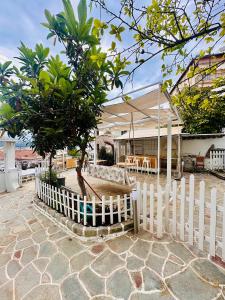 a white picket fence in front of a house at The Garden House in Kavála