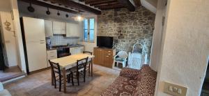a kitchen and dining room with a table and chairs at La Benabbiana in Bagni di Lucca