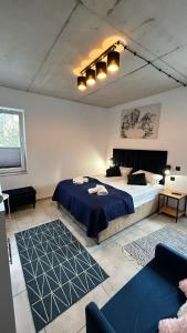a bedroom with a large bed and a couch at Za Murem in Sandomierz