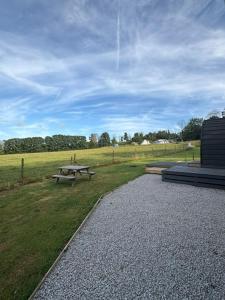 a picnic table in the middle of a field at Trevessa camping pod in Saint Erth