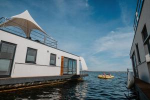 a group of people on a boat in the water at Floatinghouse KonTiki - LP8 in Vetschau