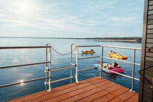 a group of people on a boat on the water at Floatinghouse KonTiki - LP8 in Vetschau +20 photos