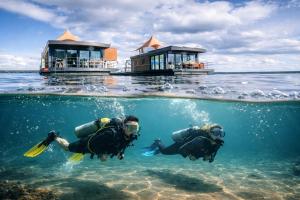 two people in the water in the ocean at Floatinghouse KonTiki - LP8 in Vetschau
