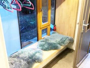 a room with a window with faux fur cushions at Ferienhaus Allrode mit Wellness in Allrode