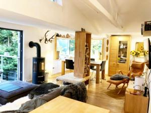 a living room with a couch and a wood stove at Ferienhaus Allrode mit Wellness in Allrode