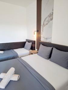 two beds in a room with two crosses on them at Apartments Perezaj II in Ulcinj