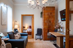a living room with a couch and a table at Zviedru Nams in Liepāja