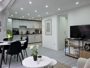 a kitchen and living room with a table and chairs at Lovely Home For You 2 in Biberach an der Riß