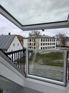 a window on a balcony with a view of a building at Lovely Home For You 2 in Biberach an der Riß