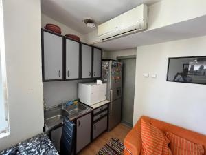 a small kitchen with a sink and a refrigerator at Sheshi-Prizren in Prizren