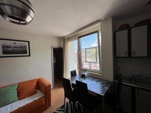 a living room with a table and a window at Sheshi-Prizren in Prizren +3 photos