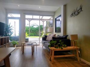 a living room with a couch and a table at "KALEE" Appartement T3 Terrasse avec petit jardin in Lanester