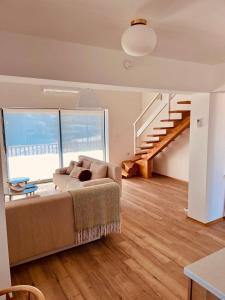 a living room with a couch and a staircase at Lemba, apartman 4 zvjezdice in Opuzen