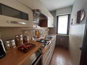 a kitchen with a sink and a stove top oven at La Chimera in Robilante