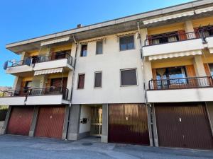 an apartment building with red garage doors at La Chimera in Robilante