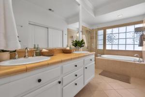 a large bathroom with two sinks and a tub at Near Oceanside Pier! Pirate in Oceanside +49 photos