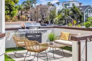 a patio with a grill and chairs and a table at Near Oceanside Pier! Pirate in Oceanside