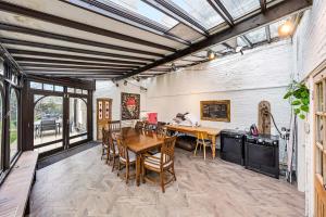 a dining room with a wooden table and chairs at Lee Valley Lodge Upper Floor in Cheshunt