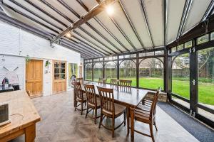 a dining room with a table and chairs at Lee Valley Lodge Upper Floor in Cheshunt