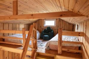 a bedroom with two bunk beds in a log cabin at Лісова Хатка in Parowa