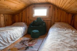 a room with two beds in a wooden cabin at Лісова Хатка in Parowa