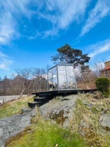 a glass box sitting on top of a hill at Brightside House in Kristiansand