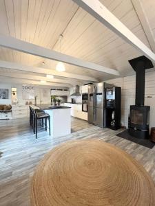 a large kitchen with a table and a stove at Brightside House in Kristiansand