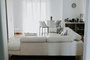 a white couch sitting in a living room at BnB Nuova Vita in Paola