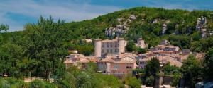 a town on top of a mountain with houses at Maison de charme, Gorges Ardèche et Nature in Vagnas
