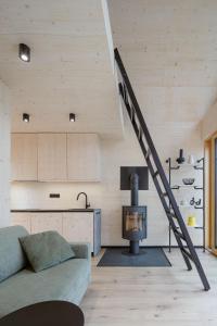 a living room with a staircase in a house at Kabiny Kravák in Znojmo