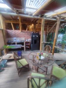 a patio with a table and chairs and a kitchen at Jui Chi MaMa Ecolodge & Birding in Palomino +37 photos