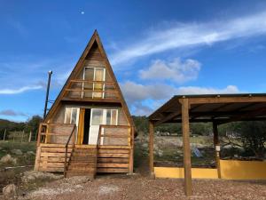 a small house with a thatched roof and windows at Don Cleto "La Mimosa" in Aiguá