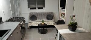 a small room with a bed in a kitchen at Studio Paisible in Nouzilly