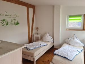 a room with two beds and a window at Sonniges Sundchalet in Stralsund