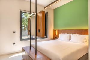a bedroom with a large bed and a window at Black Mountain Villas in Kefallonia +48 photos