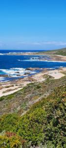 an aerial view of a beach and the ocean at 65 Rowweklip in Jongensfontein