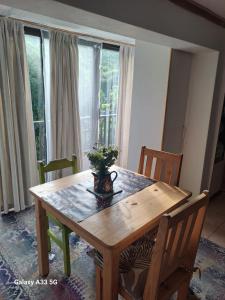 a dining room table with a vase on it at 65 Rowweklip in Jongensfontein