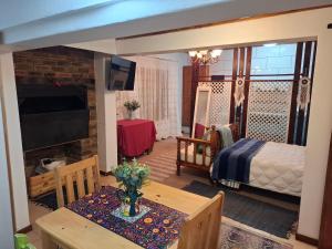 a living room with a table and a bedroom at 65 Rowweklip in Jongensfontein