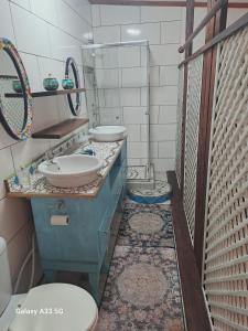 a bathroom with two sinks and a toilet at 65 Rowweklip in Jongensfontein