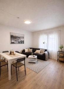 a living room with a couch and a table at Apartment 3 Sea Centrum Stavanger in Stavanger