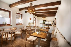 a restaurant with tables and chairs and a couch at Penzion Pawlowitz in Velké Pavlovice