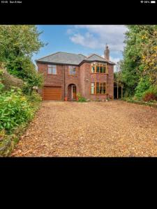 a large brick house with a large driveway at Beautiful views spacious 4 bed detached in Alvanley