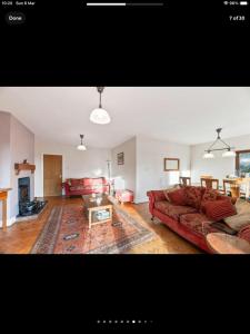 a living room with a couch and a table at Beautiful views spacious 4 bed detached in Alvanley