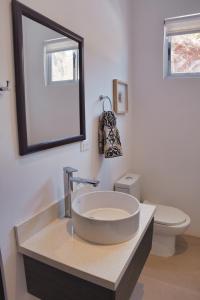 a bathroom with a sink and a toilet at Ocean View Tranquility 2BR with Pool in San Juanillo +24 photos