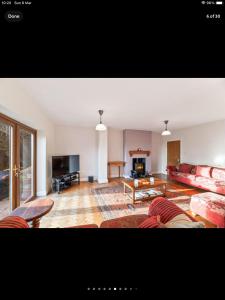 a living room with a couch and a table at Beautiful views spacious 4 bed detached in Alvanley